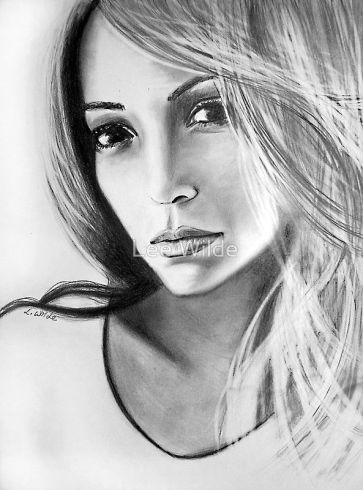 **Alt text:** Black‑and‑white portrait drawing of a woman with long flowing hair and a calm, introspective expression. Her head is slightly tilted, eyes softly focused, and light falls across her face to emphasize contour and emotion. Artwork by Lee Wilde.