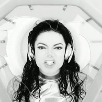 Close-up of Michael Jackson’s anguished expression as he sings “Stop pressurin’ me,” surrounded by sterile white walls.