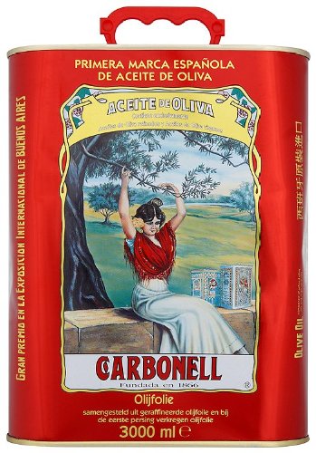 Vintage Carbonell olive oil tin featuring a Spanish woman in traditional attire beneath an olive tree, evoking pastoral beauty and early artistic memory.