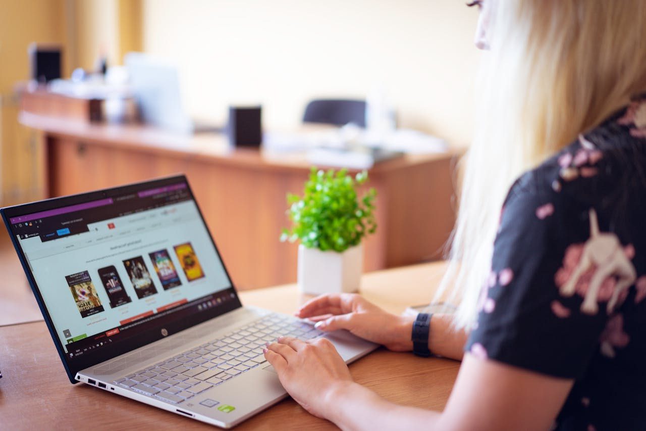 Woman sitting at computer, doing online shopping