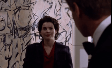 Julia Ormond in a scene from Sabrina (1995), standing before Willem de Kooning’s 1949 Abstract Expressionist painting Attic, visible in the background of a corporate interior.