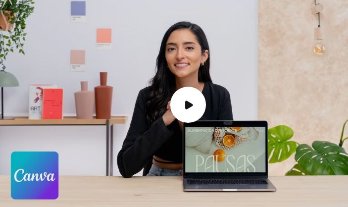 Young woman sits at desk ready to give instructions on how to use Canva