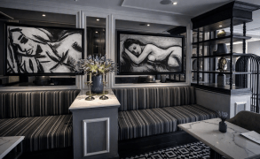 Abstract figurative paintings ‘Sansara’ in monochrome charcoal style displayed in a contemporary grey restaurant interior — figurative art for hospitality spaces.