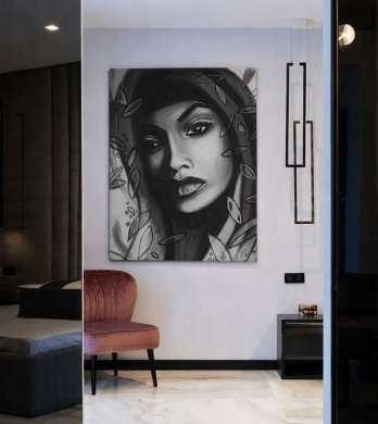 Large monochrome portrait titled “Gita” displayed unframed on a penthouse wall with marble flooring and minimalist lighting — an example of Penthouse Wall Art Ideas for High Ceilings.