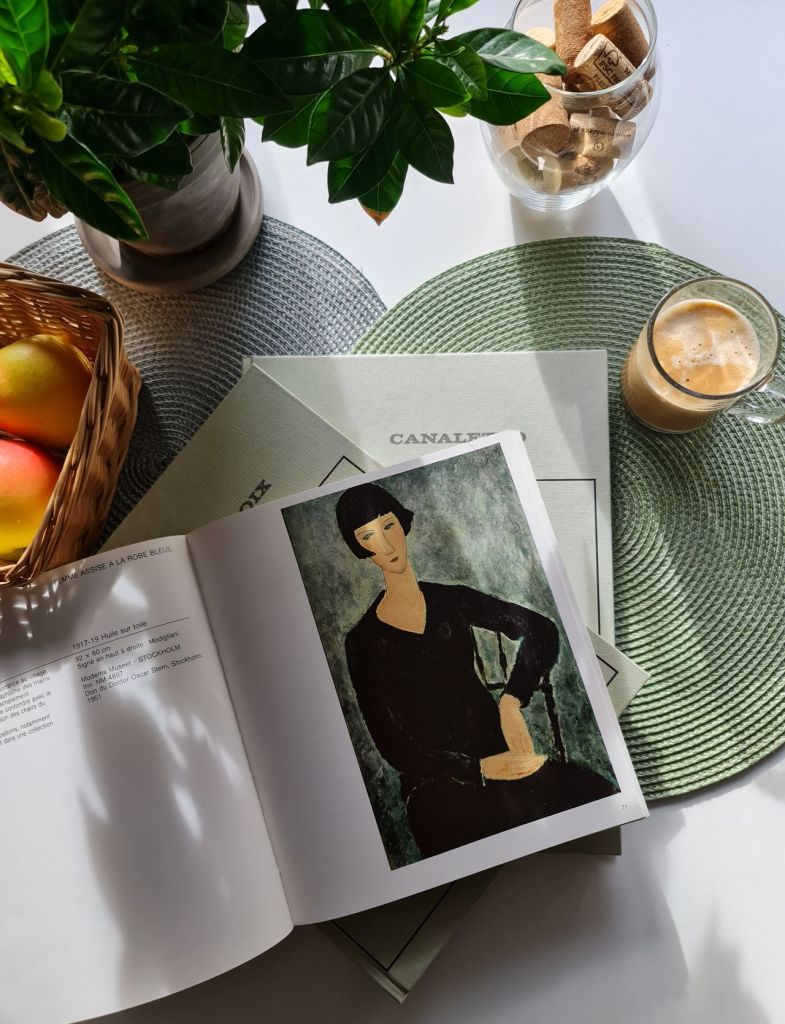 Alt image text: Collage of personal photos showing a man and woman together in various settings — sitting outdoors on a bench, posing beside a grey Chevrolet car, and smiling indoors near a bookshelf filled with art and design books — capturing relaxed, everyday moments and shared experiences.